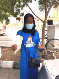 A Sierra Leonean women being repatriated by Do Bold picks up her Emergency Travel Certificates in June 2021.